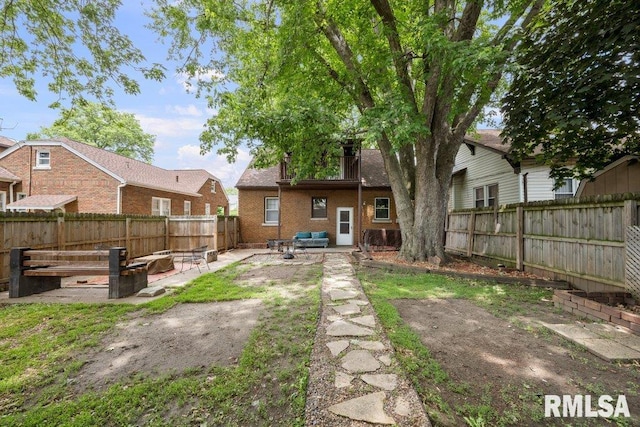 2446 16th Ave, Moline, IL 61265 - rear view of property featuring a patio area, a fenced backyard, brick siding, and a fire pit