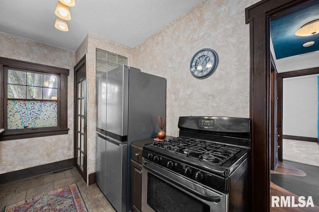 2446 16th Ave, Moline, IL 61265 - kitchen featuring stainless steel appliances, baseboards, and wallpapered walls