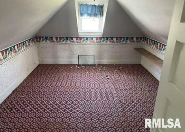 207 W Wilson St, New London, IA 52645 - bonus room with vaulted ceiling, carpet floors, and baseboards