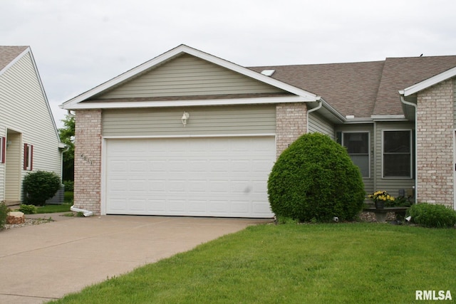 4011 Prairie Ln, Bettendorf, IA 52722 - view of front of house with brick siding, driveway, roof with shingles, and a front lawn