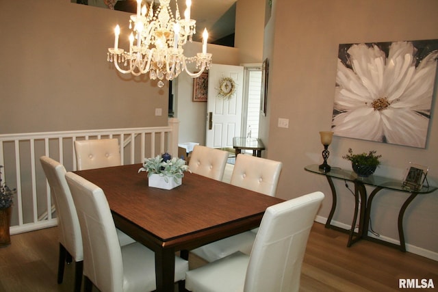 4011 Prairie Ln, Bettendorf, IA 52722 - dining space featuring wood finished floors, a chandelier, baseboards, and vaulted ceiling