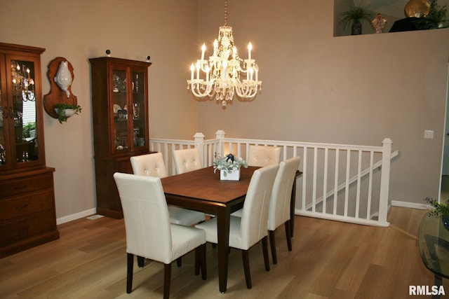 4011 Prairie Ln, Bettendorf, IA 52722 - dining space featuring a chandelier, wood finished floors, and baseboards