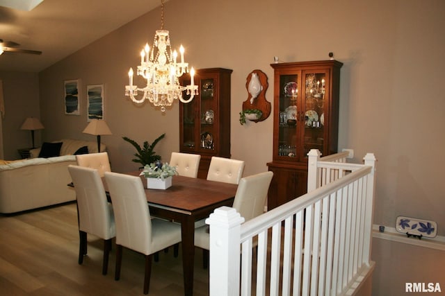 4011 Prairie Ln, Bettendorf, IA 52722 - dining space with lofted ceiling, wood finished floors, a chandelier, and a ceiling fan