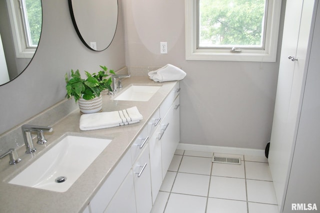 4011 Prairie Ln, Bettendorf, IA 52722 - bathroom with double vanity, tile patterned flooring, and baseboards