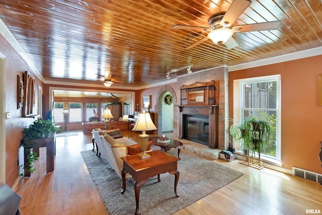 905 1st St, Camanche, IA 52730 - living room featuring a ceiling fan, wooden ceiling, a fireplace, hardwood / wood-style floors, and ornamental molding