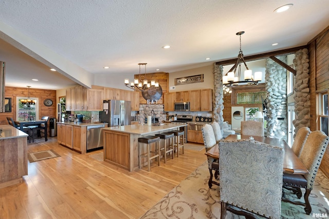 905 1st St, Camanche, IA 52730 - dining area with a chandelier, rustic walls, healthy amount of natural light, light wood-style floors, and recessed lighting