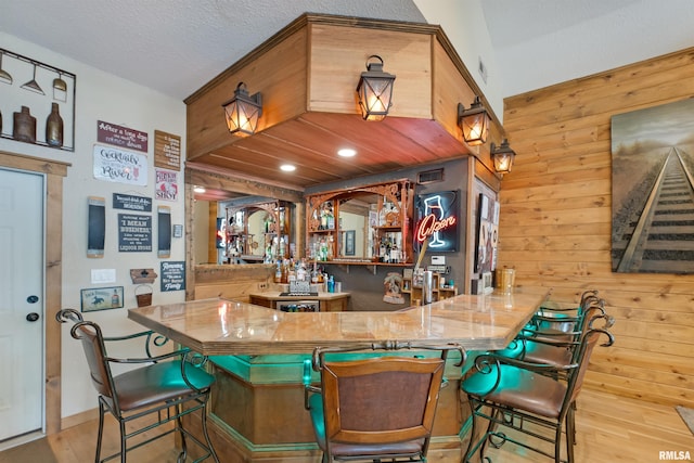 905 1st St, Camanche, IA 52730 - indoor wet bar with wooden walls, wood finished floors, and recessed lighting