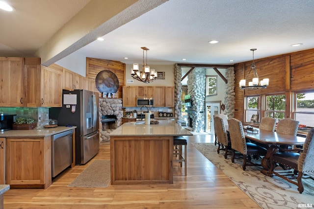 905 1st St, Camanche, IA 52730 - kitchen with stainless steel appliances, a chandelier, backsplash, recessed lighting, and light wood-type flooring