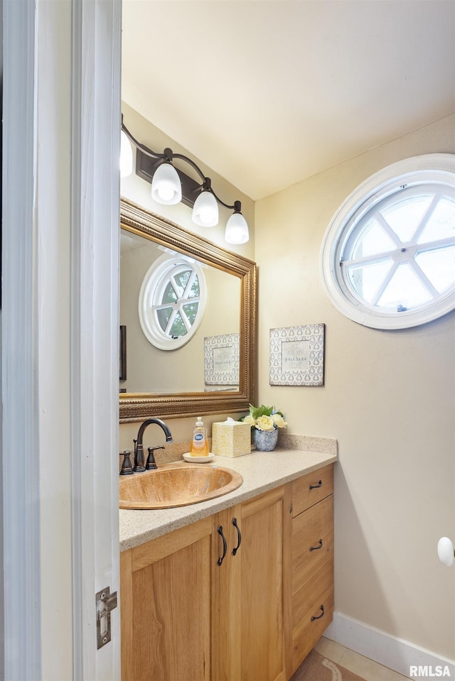 905 1st St, Camanche, IA 52730 - bathroom featuring vanity, plenty of natural light, tile patterned floors, and baseboards