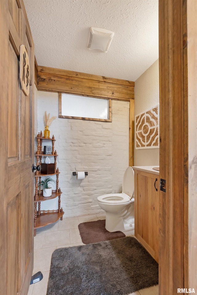 905 1st St, Camanche, IA 52730 - bathroom with tile patterned floors, toilet, vanity, and a textured ceiling
