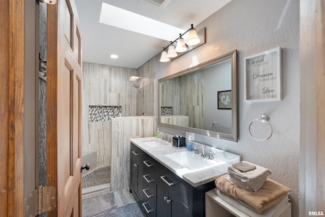 905 1st St, Camanche, IA 52730 - full bath with walk in shower, double vanity, and a textured wall