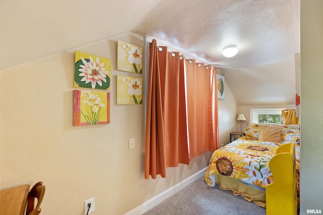 905 1st St, Camanche, IA 52730 - carpeted bedroom with vaulted ceiling and baseboards