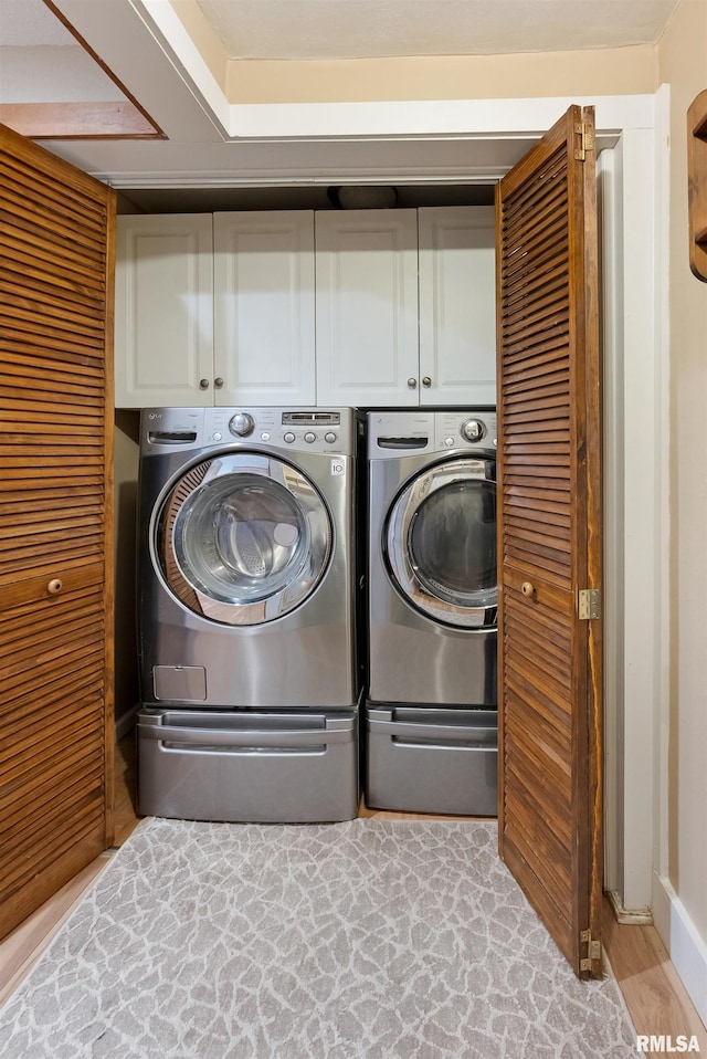 905 1st St, Camanche, IA 52730 - laundry room featuring cabinet space and washer and clothes dryer