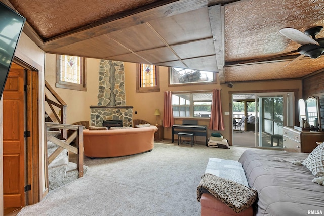 905 1st St, Camanche, IA 52730 - living area featuring carpet, ceiling fan, and a stone fireplace