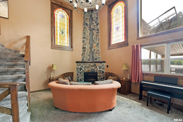905 1st St, Camanche, IA 52730 - living area featuring a chandelier, carpet floors, a towering ceiling, stairway, and baseboards