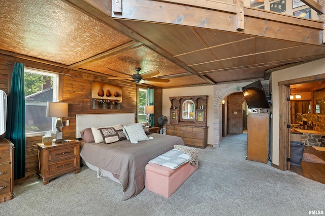905 1st St, Camanche, IA 52730 - carpeted bedroom featuring arched walkways and wood walls