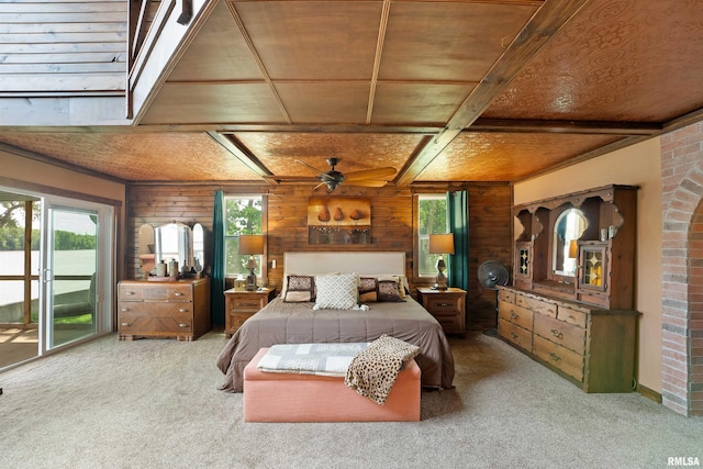 905 1st St, Camanche, IA 52730 - carpeted bedroom featuring wood walls, multiple windows, wooden ceiling, and access to outside