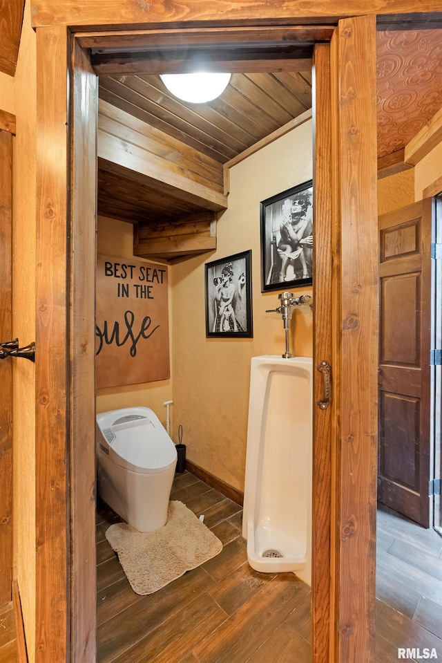 905 1st St, Camanche, IA 52730 - bathroom with toilet, wood finished floors, wooden ceiling, and baseboards