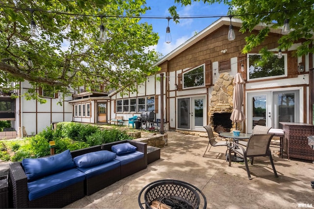 905 1st St, Camanche, IA 52730 - view of patio / terrace with french doors and an outdoor living space with a fire pit