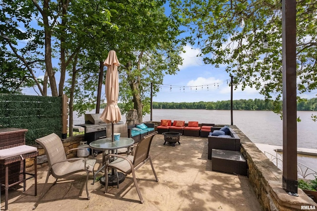 905 1st St, Camanche, IA 52730 - view of patio / terrace featuring an outdoor living space with a fire pit and a water view