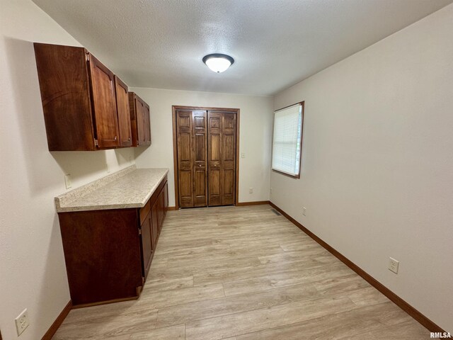 1492 45th St, New Boston, IL 61272 - foyer entrance with light wood-type flooring, baseboards, and a textured ceiling