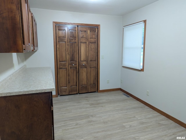 1492 45th St, New Boston, IL 61272 - unfurnished bedroom featuring light wood-style floors, baseboards, and a closet