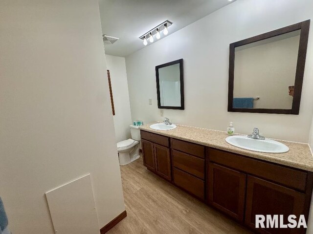 1492 45th St, New Boston, IL 61272 - full bath featuring double vanity, toilet, and wood finished floors