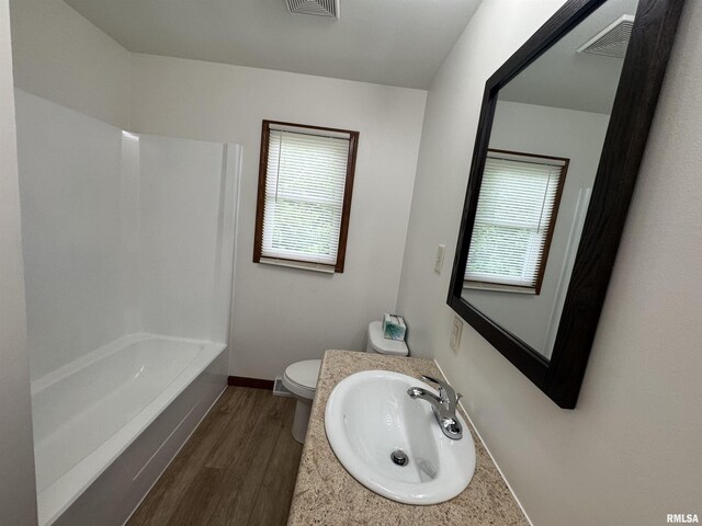 1492 45th St, New Boston, IL 61272 - full bath featuring plenty of natural light, wood finished floors, toilet, and vanity