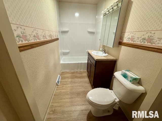 1492 45th St, New Boston, IL 61272 - bathroom featuring a textured wall, wood finished floors, vanity, toilet, and wallpapered walls