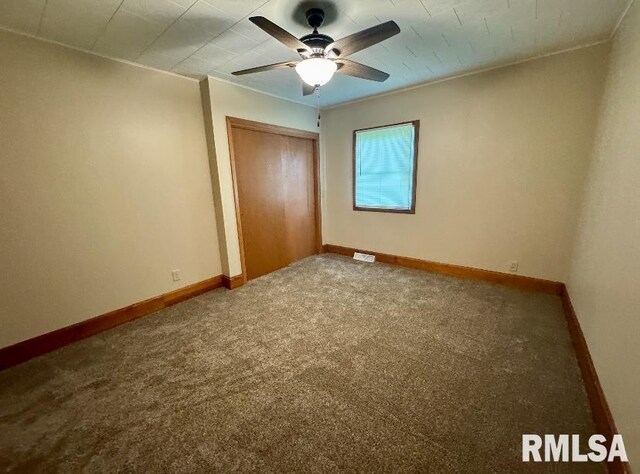 1492 45th St, New Boston, IL 61272 - unfurnished bedroom with a closet, baseboards, carpet flooring, and ceiling fan