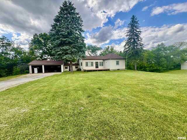 1492 45th St, New Boston, IL 61272 - ranch-style home featuring driveway, an outbuilding, an attached garage, and a front lawn