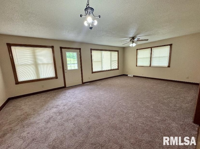 1492 45th St, New Boston, IL 61272 - carpeted empty room with a textured ceiling, a ceiling fan, baseboards, and a chandelier