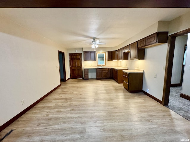 1492 45th St, New Boston, IL 61272 - kitchen featuring a sink, ceiling fan, light wood finished floors, baseboards, and light countertops