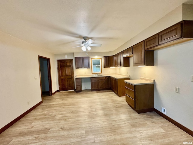 1492 45th St, New Boston, IL 61272 - kitchen with a sink, ceiling fan, baseboards, and light wood finished floors