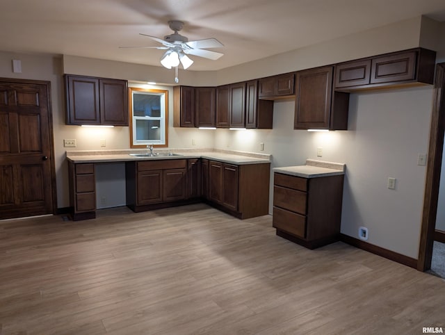1492 45th St, New Boston, IL 61272 - kitchen featuring ceiling fan, baseboards, a sink, dark brown cabinets, and light wood-style flooring