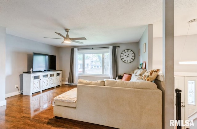 3071 S Hampton Dr, Bettendorf, IA 52722 - living area featuring a textured ceiling, wood finished floors, a ceiling fan, and baseboards