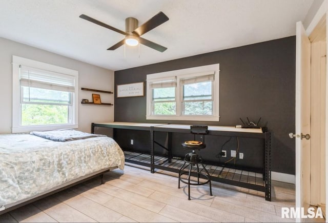 3071 S Hampton Dr, Bettendorf, IA 52722 - bedroom featuring multiple windows and a ceiling fan