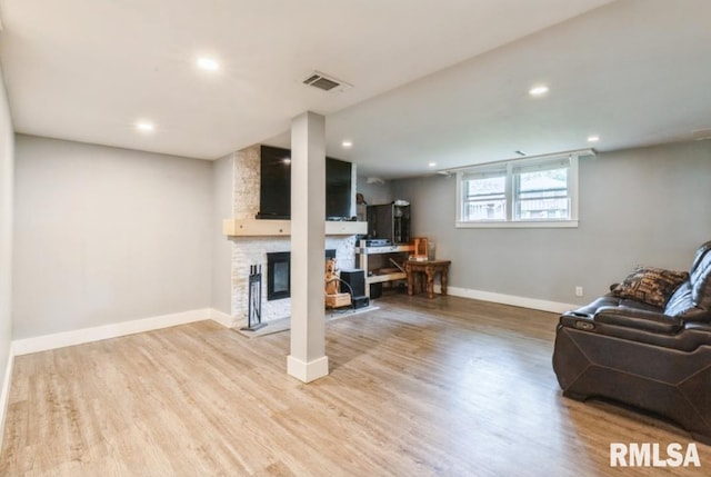 3071 S Hampton Dr, Bettendorf, IA 52722 - living area with light wood-type flooring, baseboards, a stone fireplace, and recessed lighting