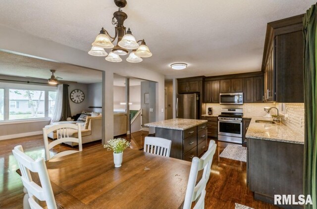 3071 S Hampton Dr, Bettendorf, IA 52722 - dining room featuring a chandelier and dark wood finished floors