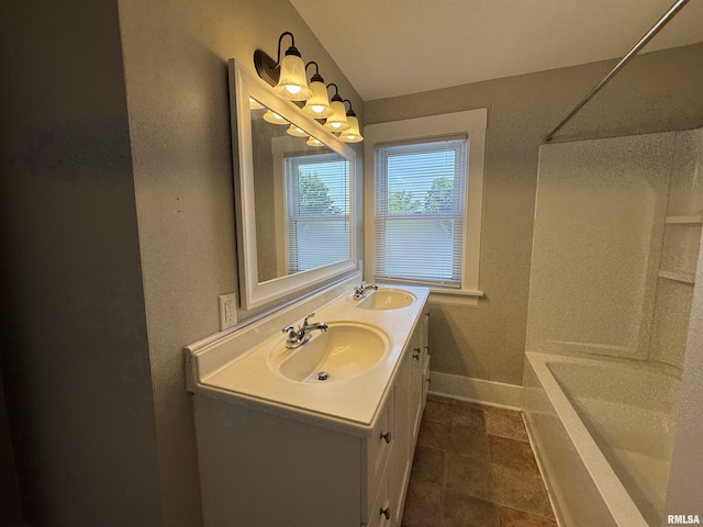 1122 E Colorado St, Davenport, IA 52803 - full bath featuring double vanity, baseboards, and shower / bathtub combination