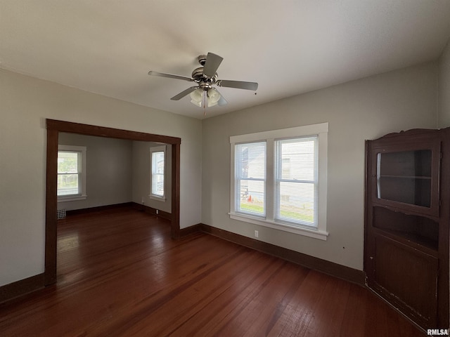 1122 E Colorado St, Davenport, IA 52803 - unfurnished room featuring baseboards, dark wood-type flooring, and a ceiling fan