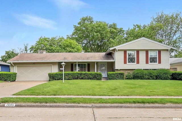 2645 Fillmore Ln, Davenport, IA 52804 - tri-level home featuring a garage, concrete driveway, and a front yard