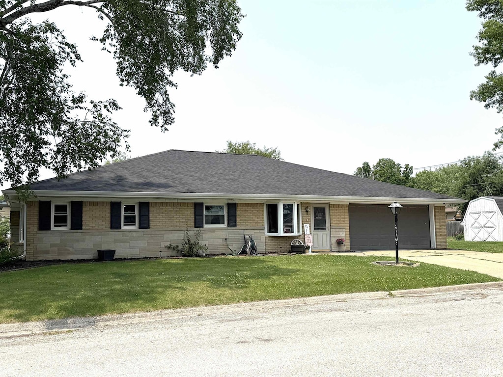 1110 7th St, Durant, IA 52747 - single story home featuring a garage, concrete driveway, a front lawn, and brick siding