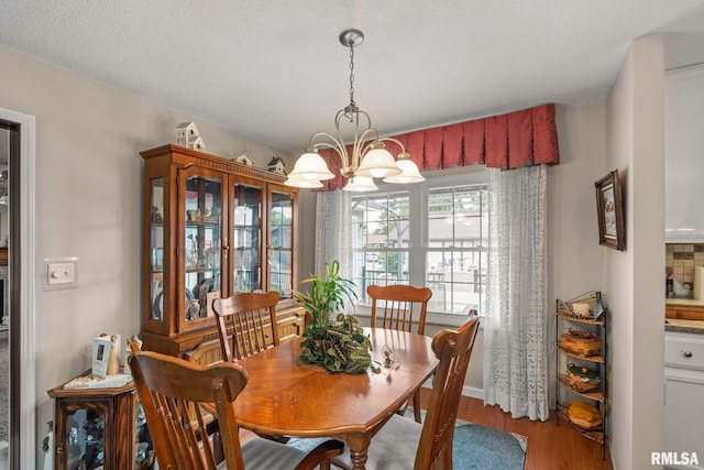 1415 W 59th St, Davenport, IA 52806 - dining area with a chandelier, wood finished floors, and baseboards
