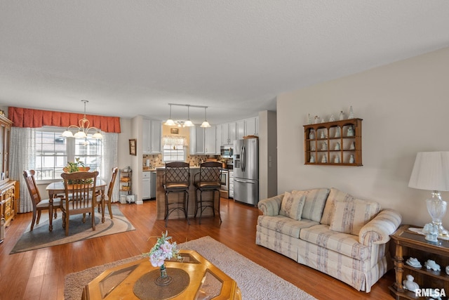 1415 W 59th St, Davenport, IA 52806 - living area with wood finished floors and a chandelier