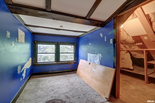 627 5th Ave S, Clinton, IA 52732 - carpeted spare room featuring beam ceiling and baseboards