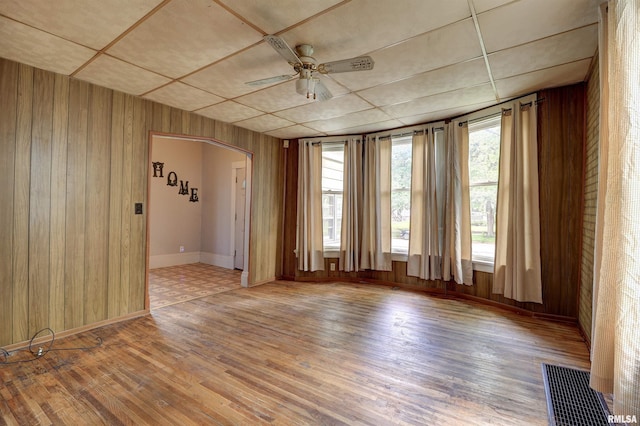 627 5th Ave S, Clinton, IA 52732 - spare room with wooden walls, wood finished floors, ceiling fan, and baseboards