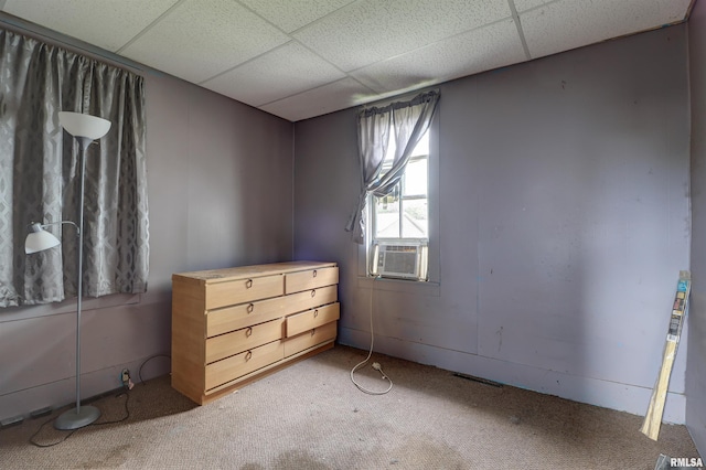 627 5th Ave S, Clinton, IA 52732 - unfurnished bedroom featuring carpet flooring, a drop ceiling, and cooling unit