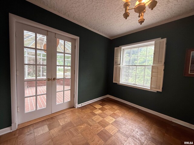 215 3rd St, Carmi, IL 62821 - spare room with healthy amount of natural light, baseboards, crown molding, french doors, and a chandelier