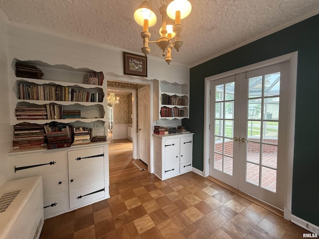 215 3rd St, Carmi, IL 62821 - dining room featuring a chandelier, french doors, a textured ceiling, light flooring, and wainscoting